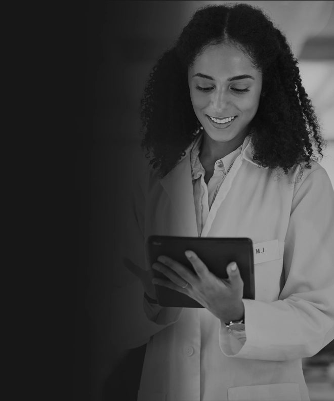 Scientist in white coat reviewing lab-tested heavy metal-free vape cartridge results on a tablet.